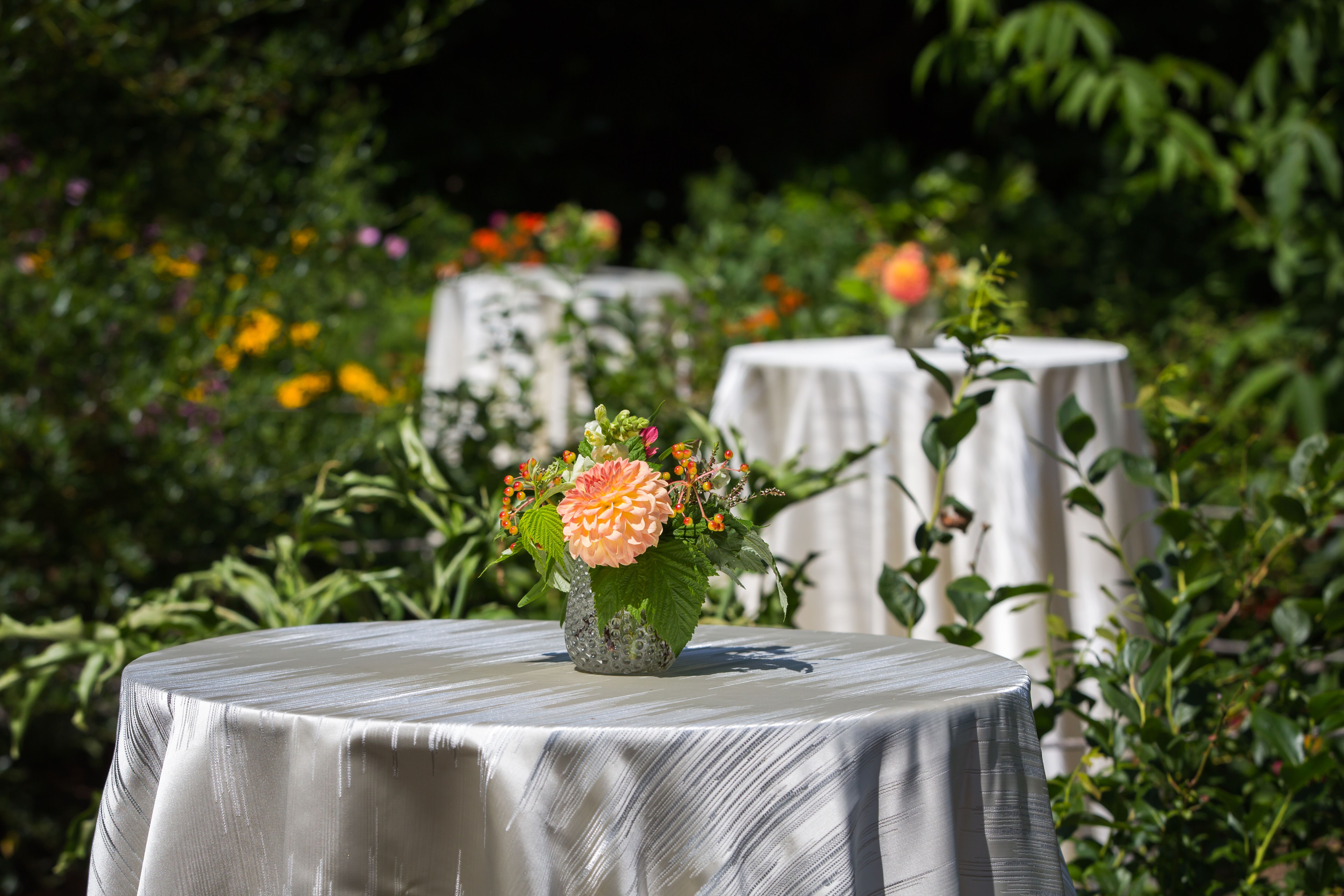 Patio cocktail tables with flower centerpieces