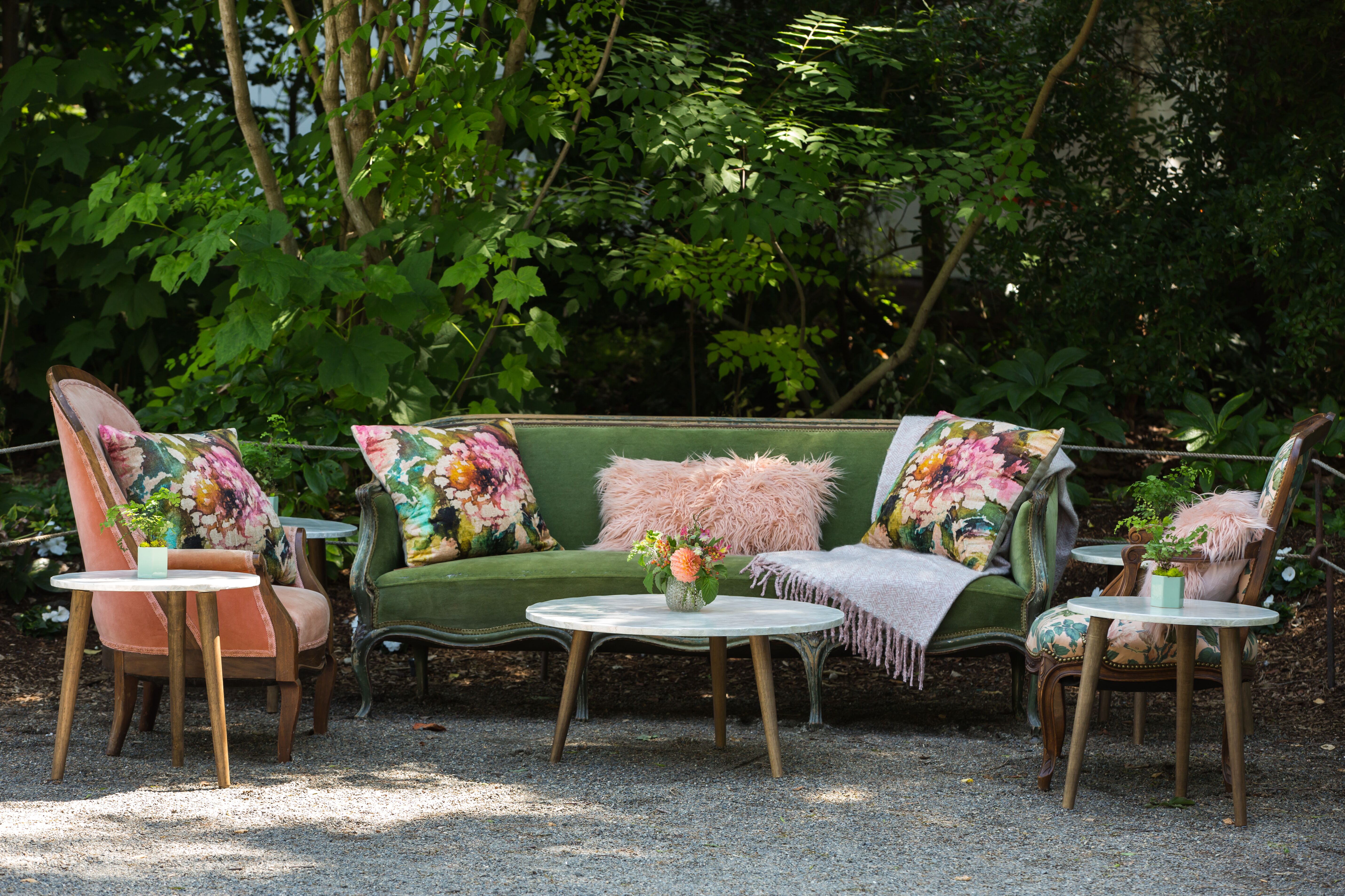 Custom event setup with furniture and floral throw pillows