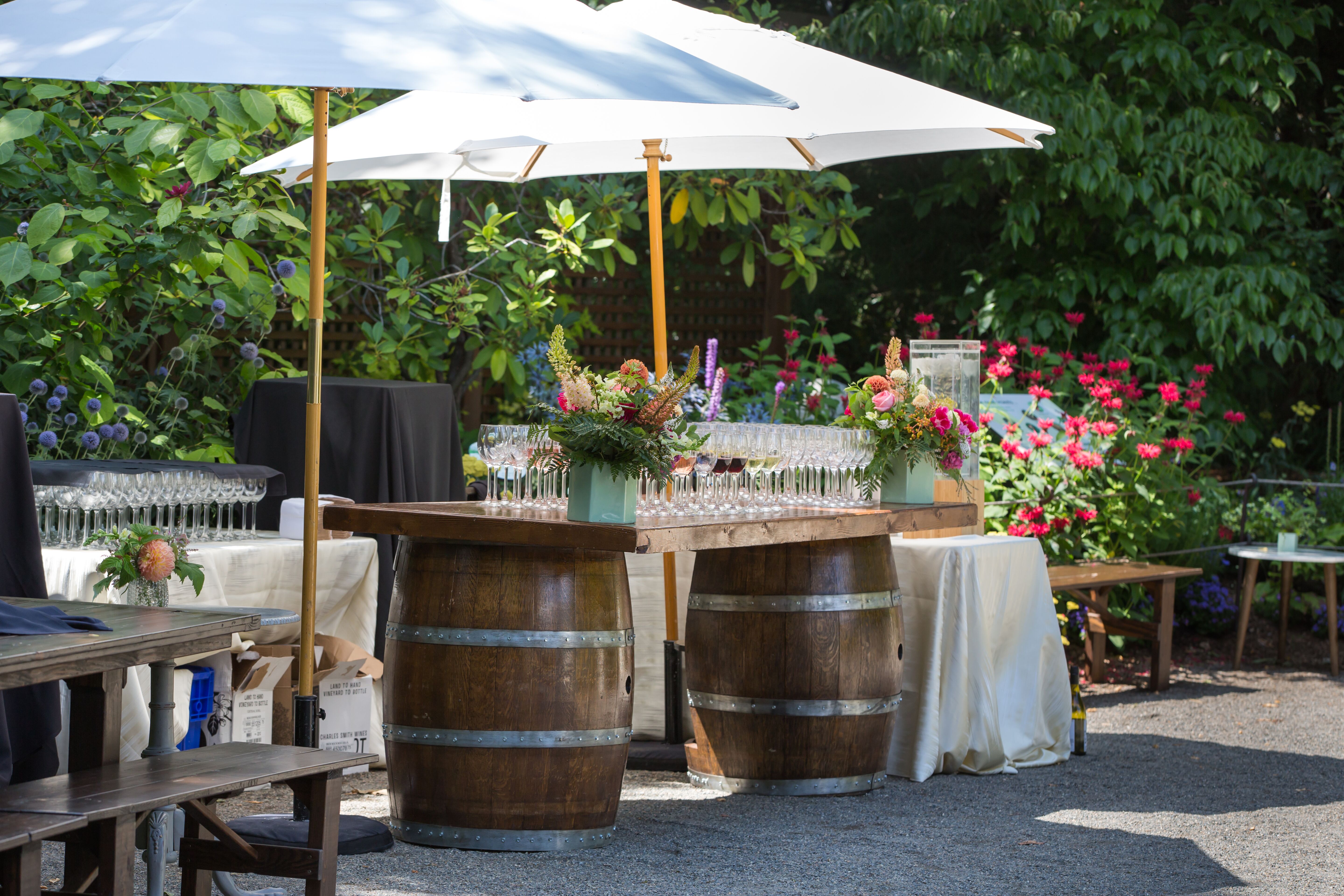Drinks table at patio with blooming flowers and bouquets